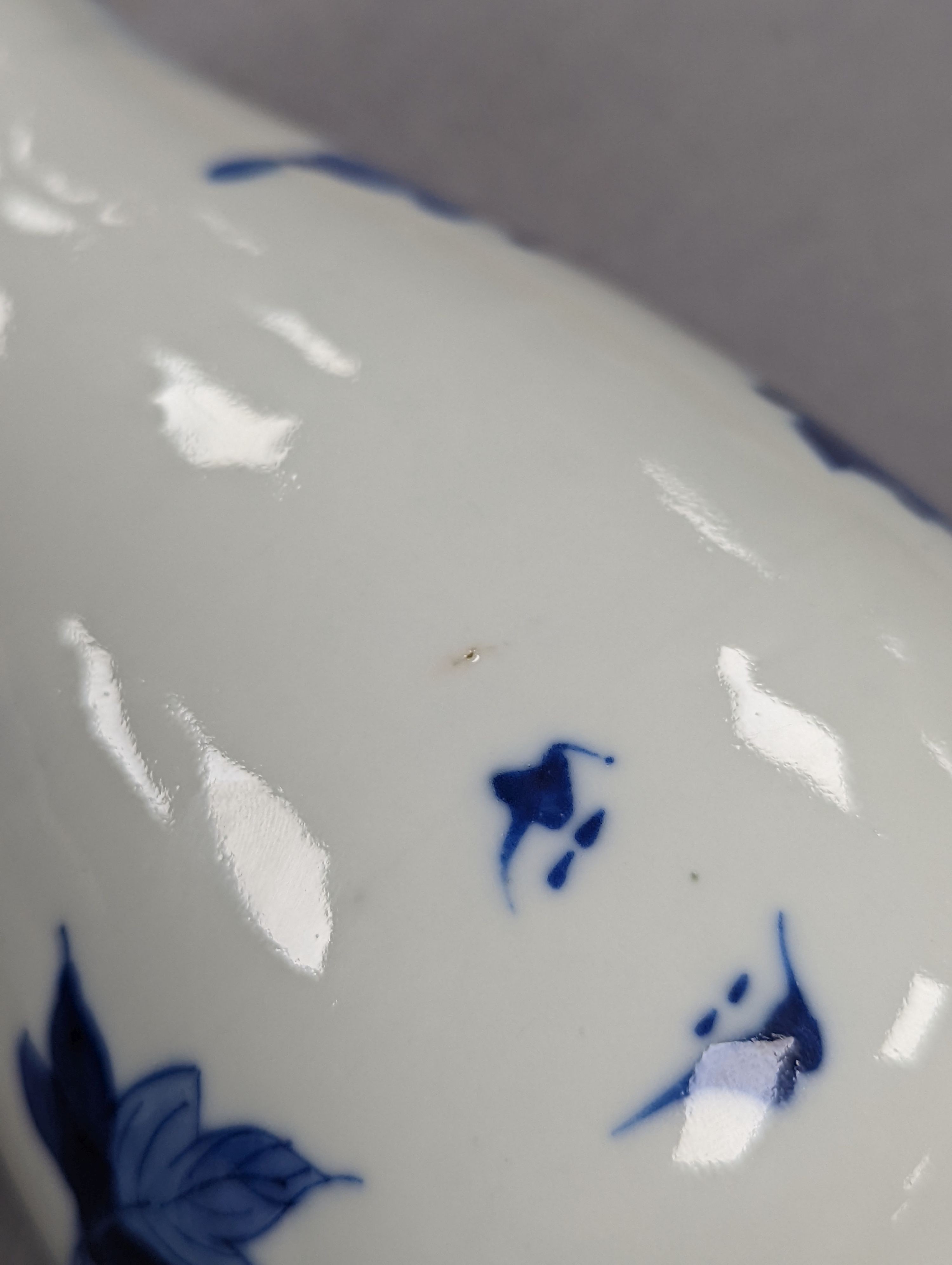 A late 19th century Chinese blue and white baluster vase, painted with birds amid flowers and rock work, pseudo Kangxi mark. 26cm